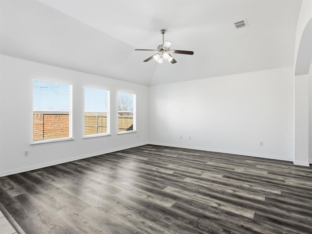 424 Shady Shore Lane Crowley, TX 76036 - Photo 23 of 40 an empty room with wooden floor fan and windows