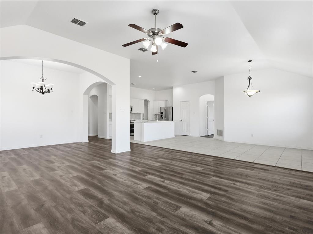 424 Shady Shore Lane Crowley, TX 76036 - Photo 25 of 40 a view of an empty room with chandelier fan and wooden floor