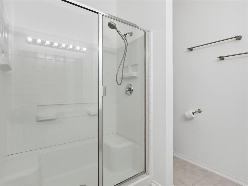 424 Shady Shore Lane Crowley, TX 76036 - Photo 32 of 40 a bathroom with a glass shower door