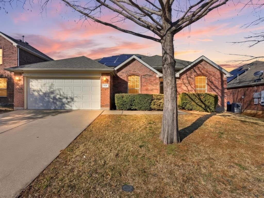 424 Shady Shore Lane Crowley, TX 76036 - Photo 5 of 40 a front view of a house with a yard and garage