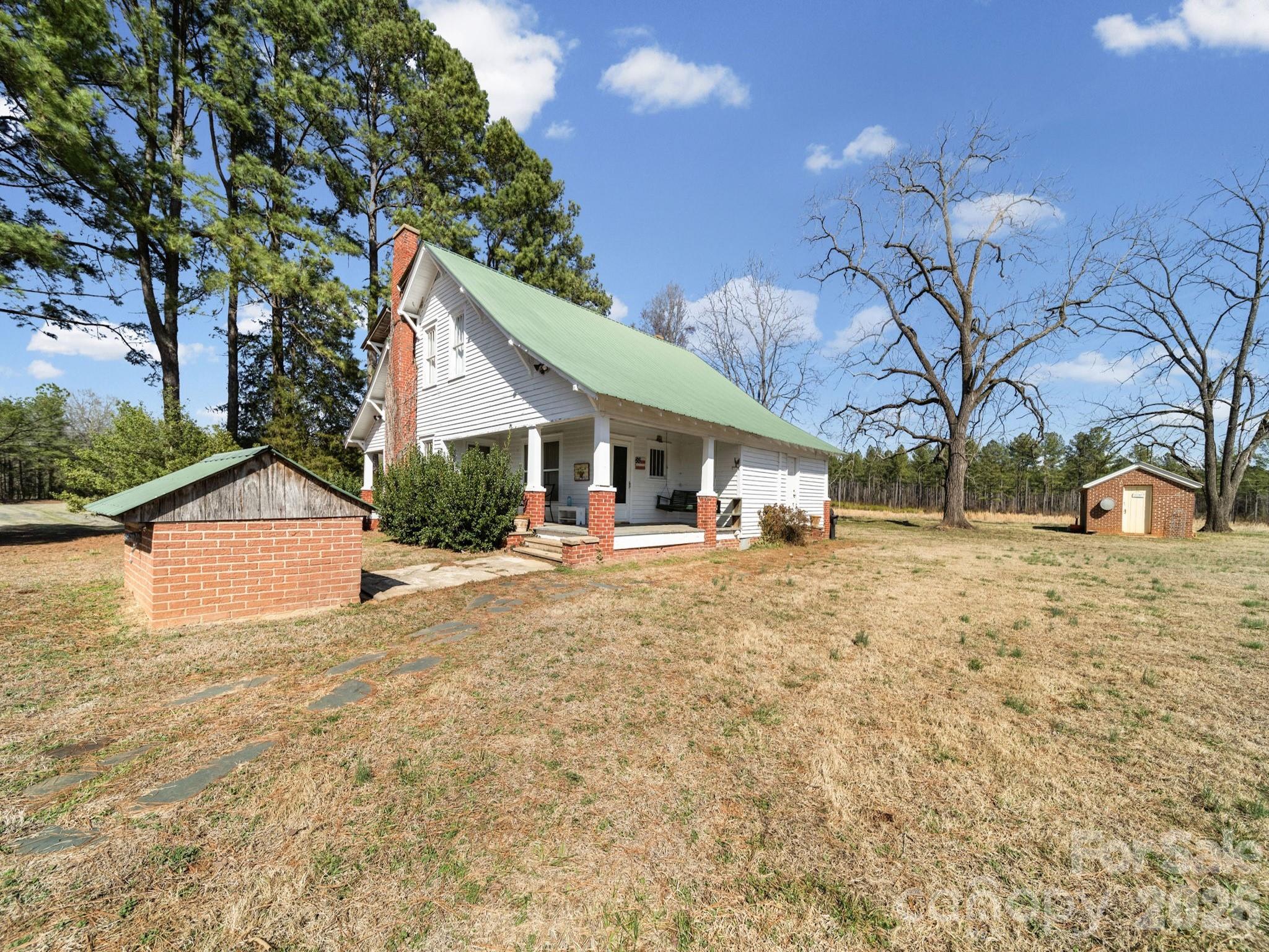 1347 Newsom Road Denton, NC 27239 - Photo 11 of 47 a front view of a house with a yard covered with snow and trees
