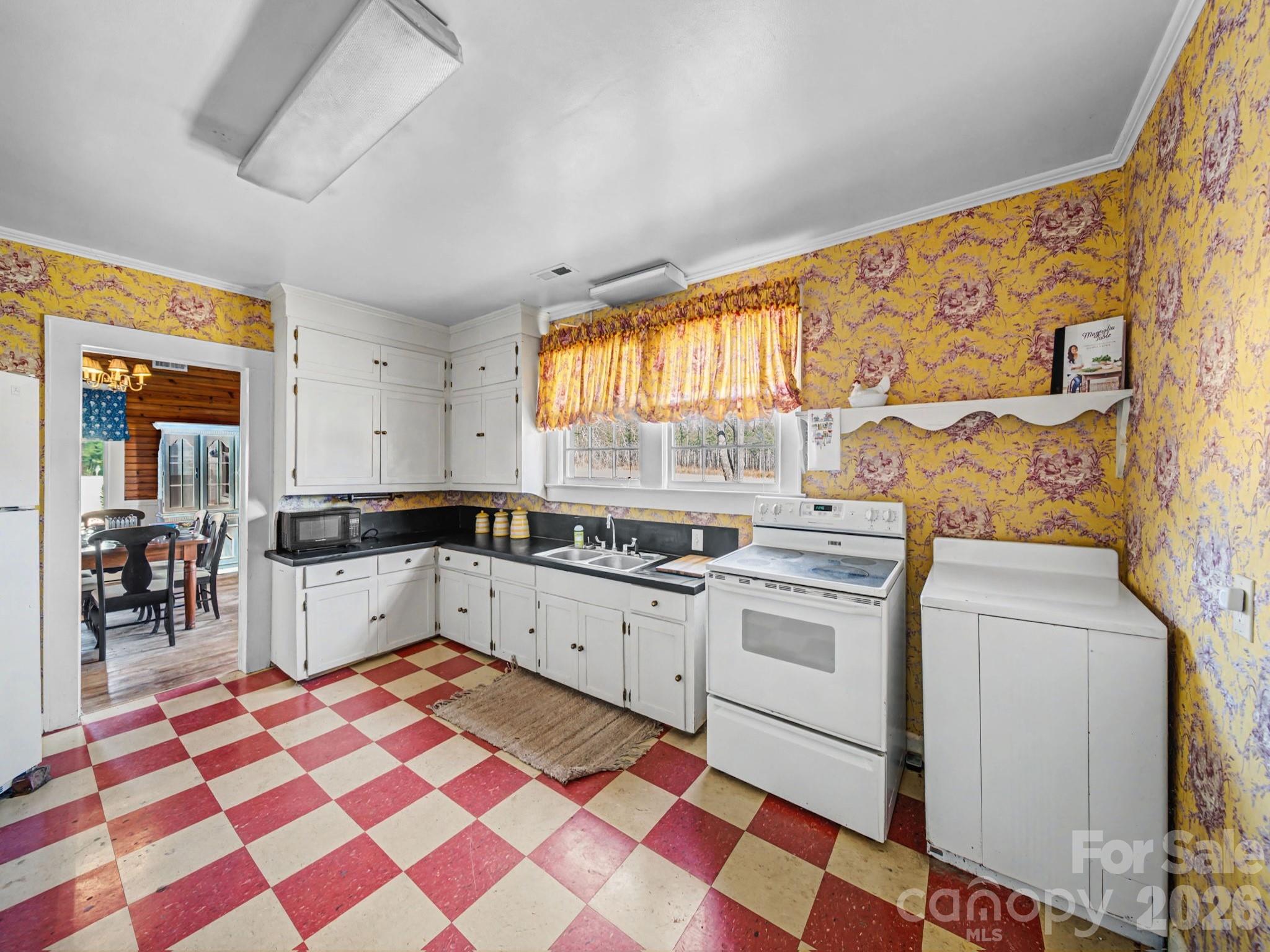 1347 Newsom Road Denton, NC 27239 - Photo 21 of 47 a kitchen with a stove a sink and a microwave