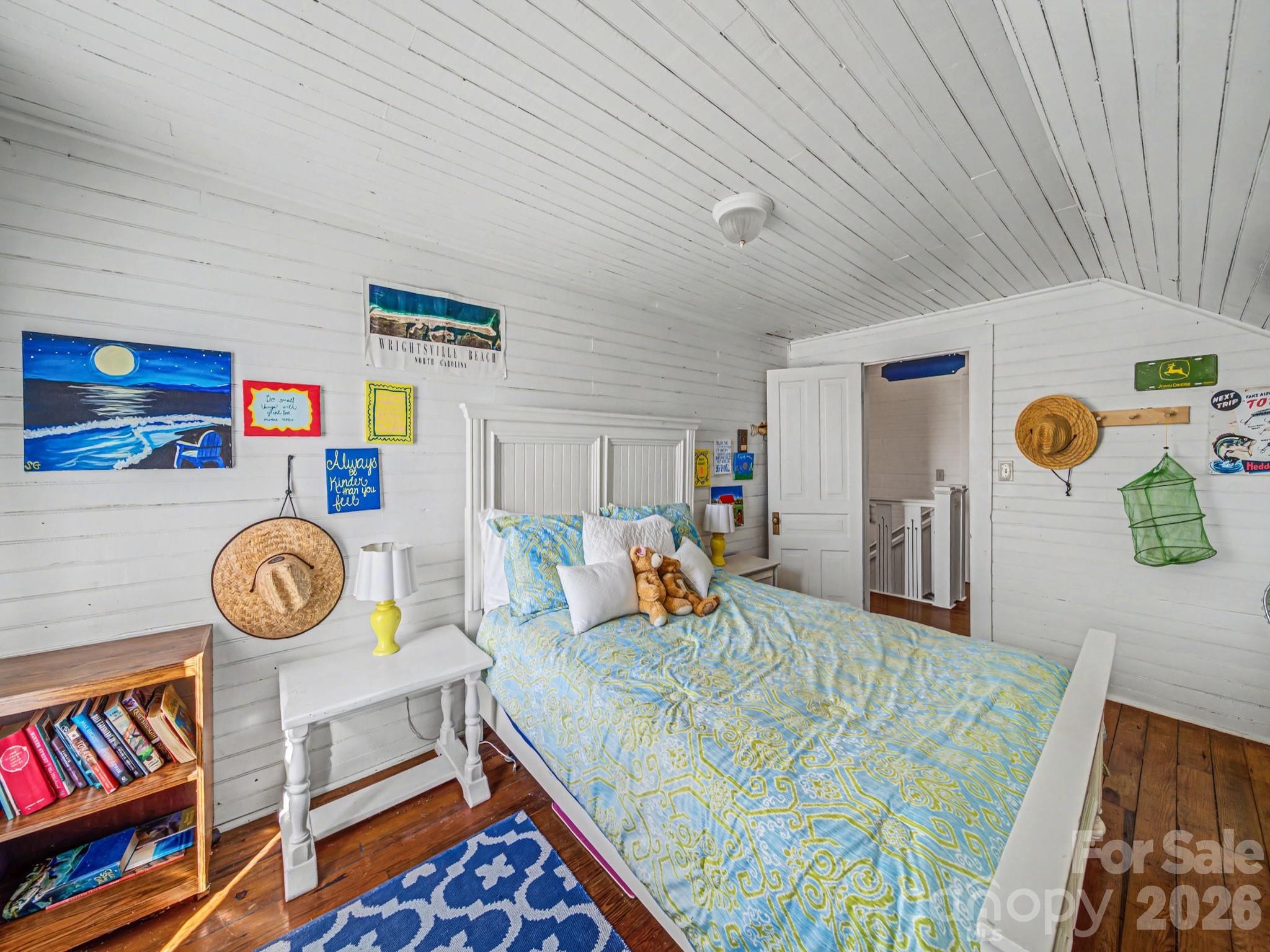 1347 Newsom Road Denton, NC 27239 - Photo 32 of 47 a bedroom with a bed and a book shelf