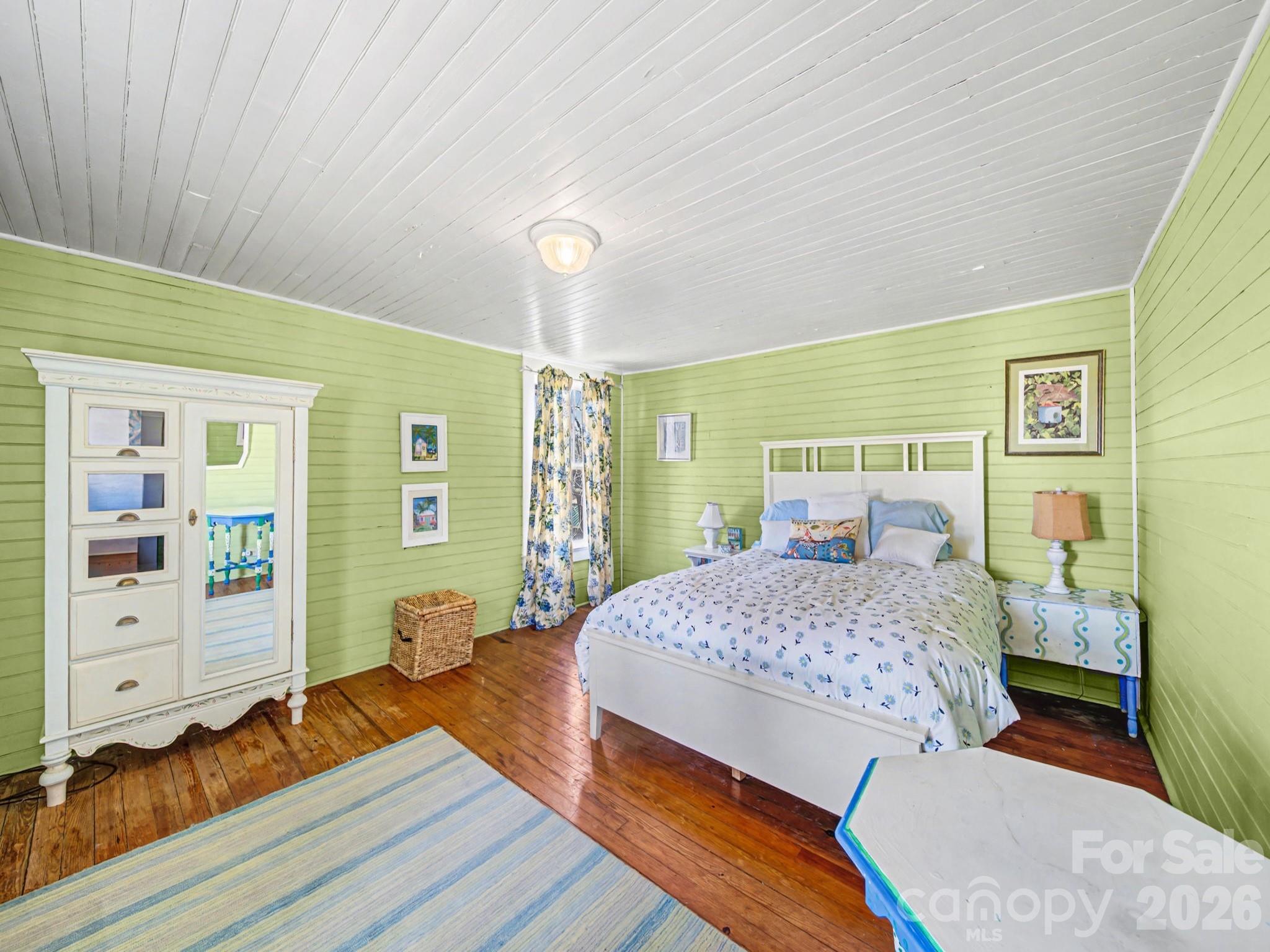 1347 Newsom Road Denton, NC 27239 - Photo 35 of 47 a bedroom with a bed and wooden floor