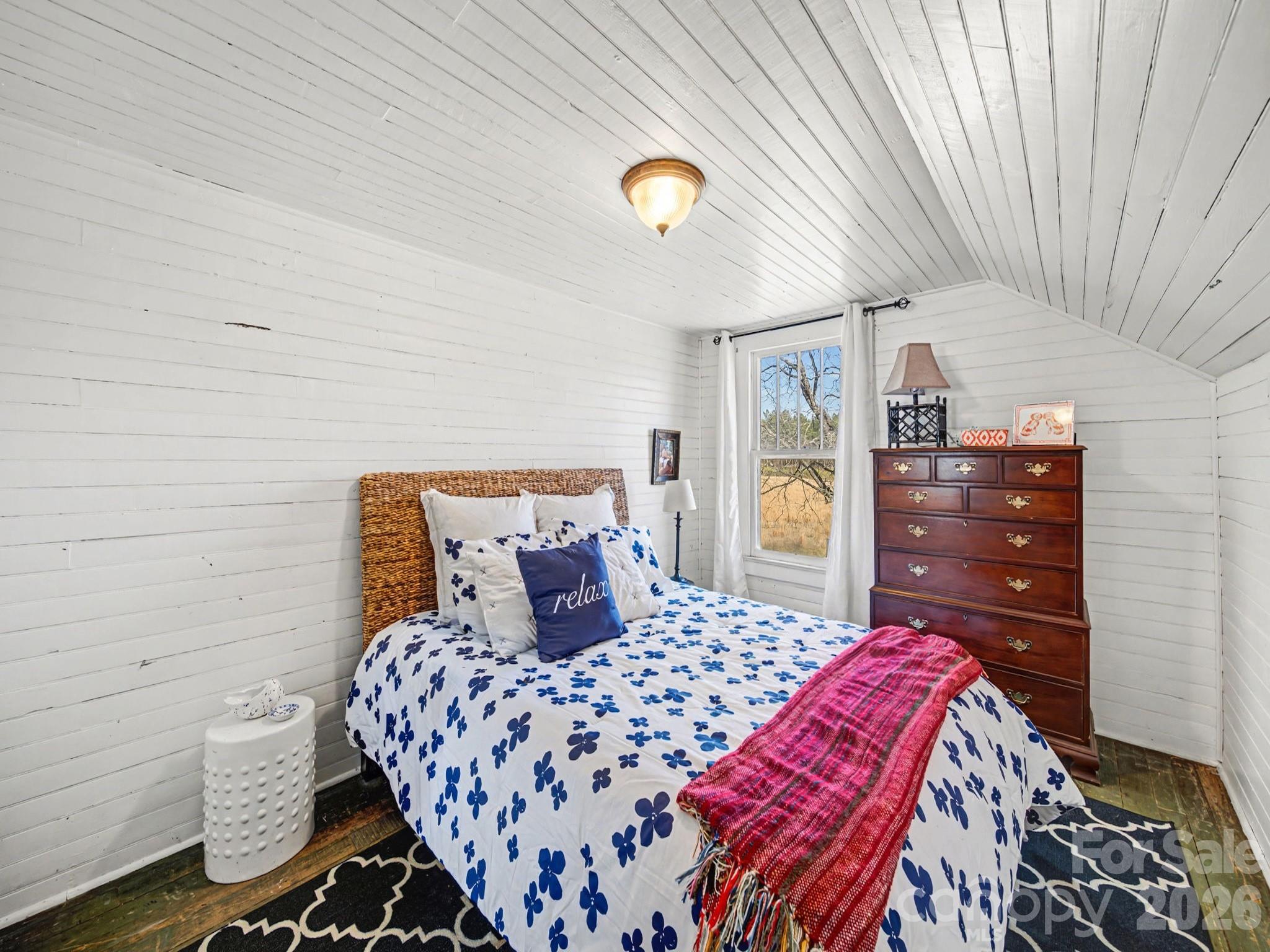 1347 Newsom Road Denton, NC 27239 - Photo 38 of 47 a bedroom with a bed and dresser with mirror