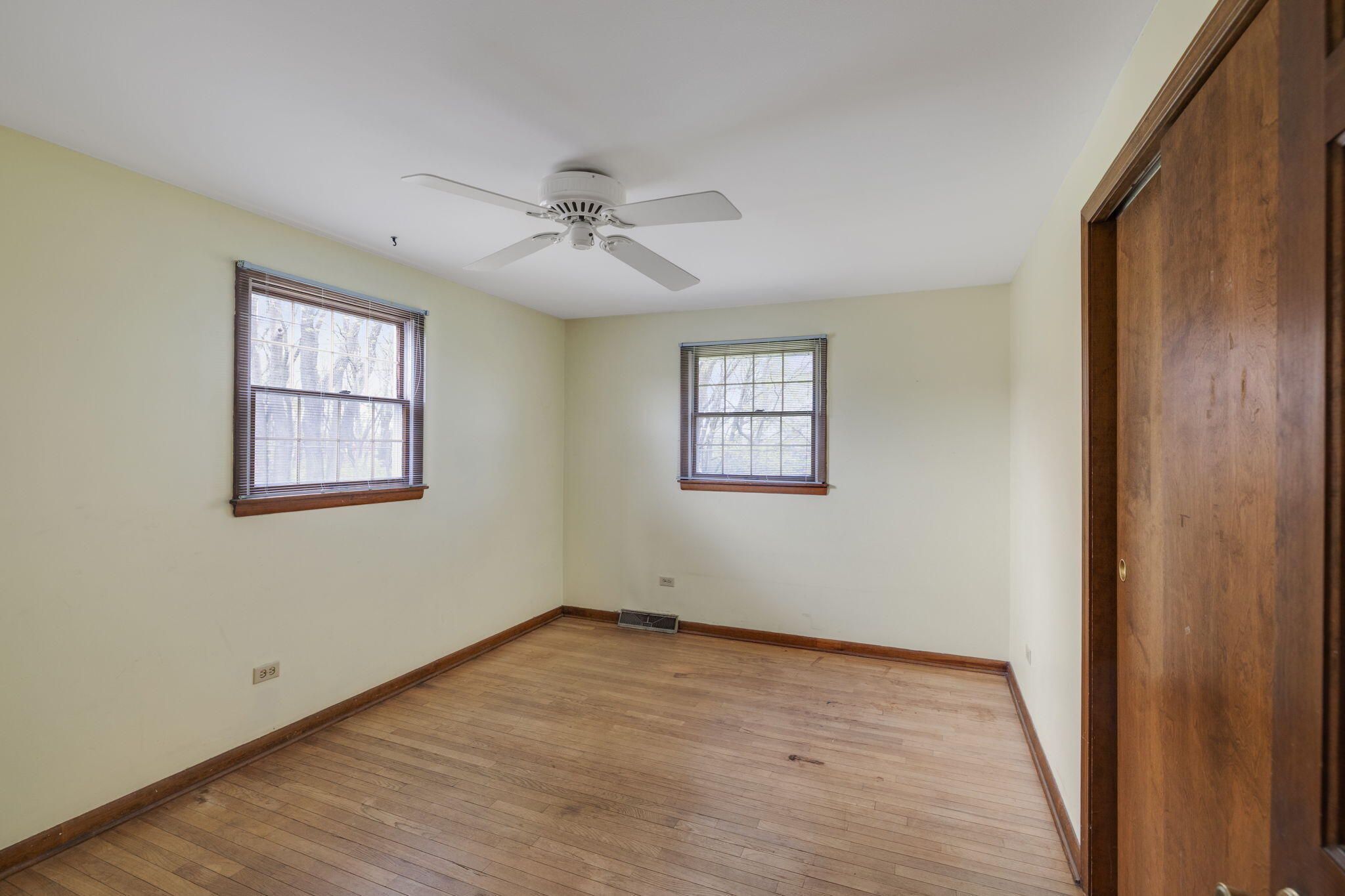218 West 38th Court Griffith, IN 46319 - Photo 17 of 23 a view of an empty room with a window and wooden floor