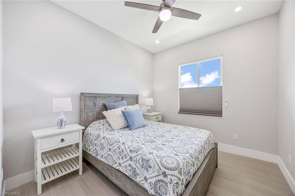 1395 Curlew Avenue, Unit 43 Naples, FL 34102 - Photo 14 of 24 a bedroom with a bed and a painting on the wall
