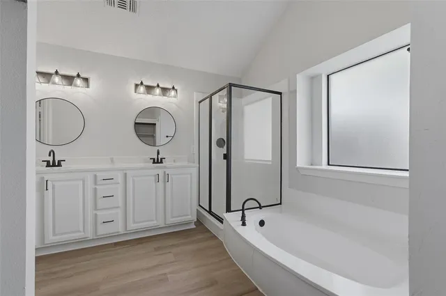a spacious bathroom with 2 sink tub and shower