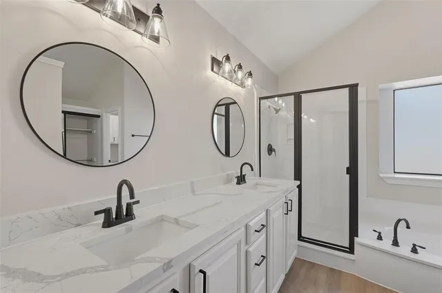 a bathroom with a double vanity sink and a mirror