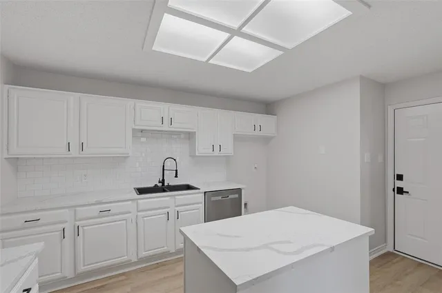 a kitchen with cabinets appliances and a counter space