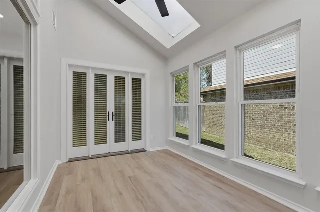 a view of an entryway with wooden floor and door