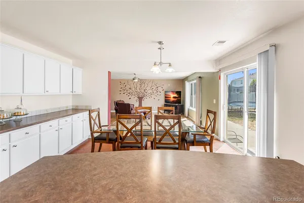 a open kitchen with granite countertop a sink cabinets and stainless steel appliances