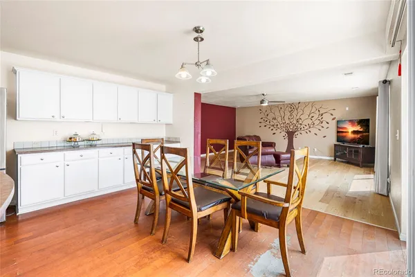 a view of a dining room with furniture and wooden floor