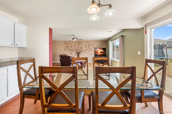 a view of a dining room with furniture and a kitchen
