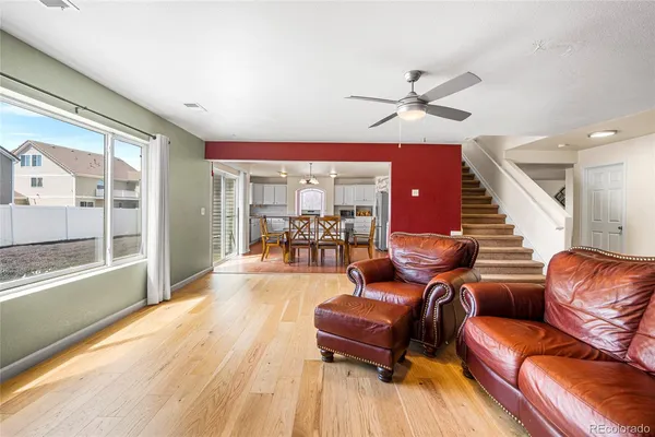 a living room with furniture and a floor to ceiling window
