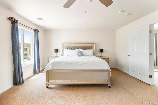 a spacious bedroom with a bed and a window