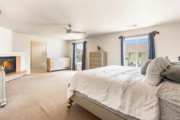 a bedroom with a bed and a fireplace