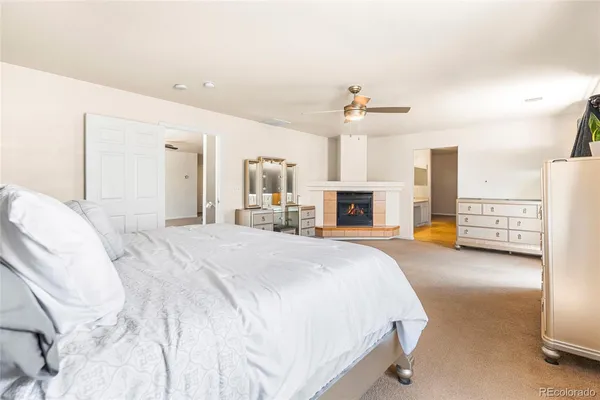 a spacious bedroom with a large bed and a chandelier