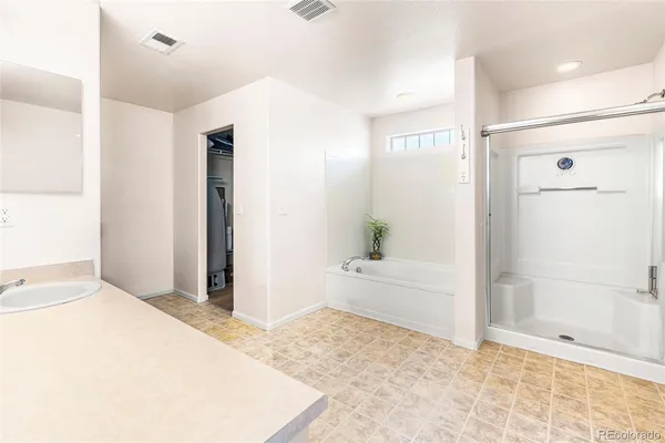 a spacious bathroom with a granite countertop sink and a mirror