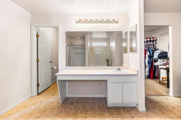 a bathroom with a tub shower and vanity