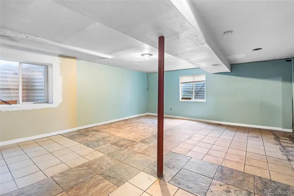 a view of a livingroom with wooden floor and kitchen space