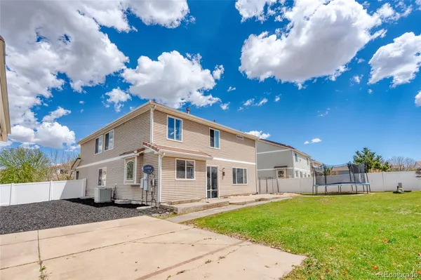 a backyard of a house with table and chairs