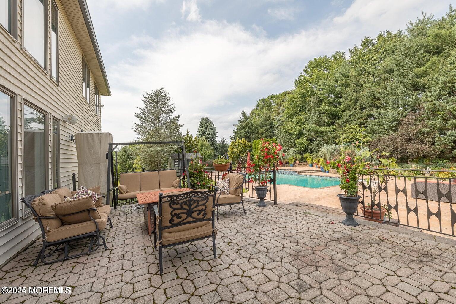 806 Turquoise Trail Morganville, NJ 07751 - Photo 31 of 62 a view of a patio with couches table and chairs and potted plants