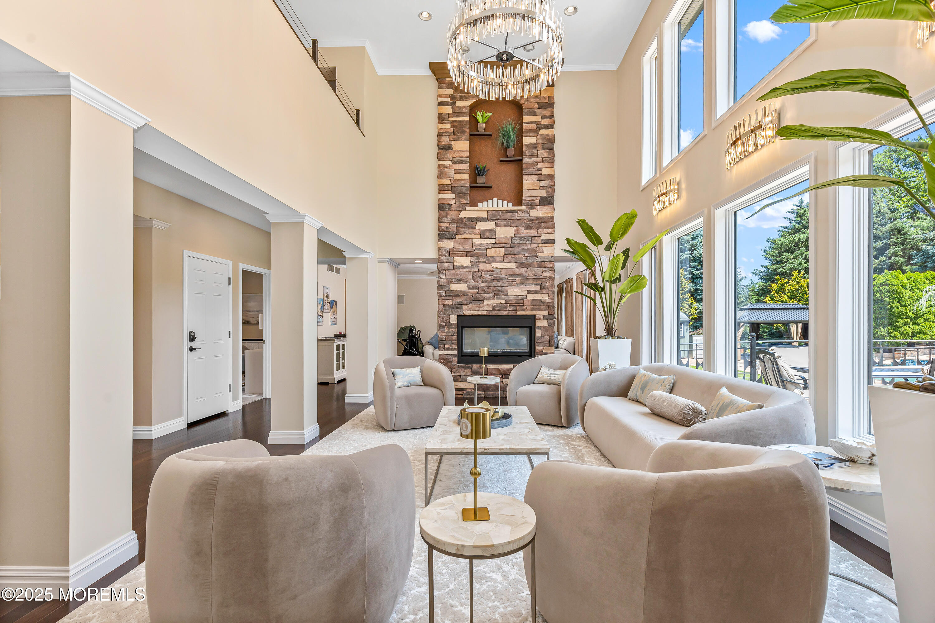 806 Turquoise Trail Morganville, NJ 07751 - Photo 6 of 62 a living room with fireplace furniture and a chandelier