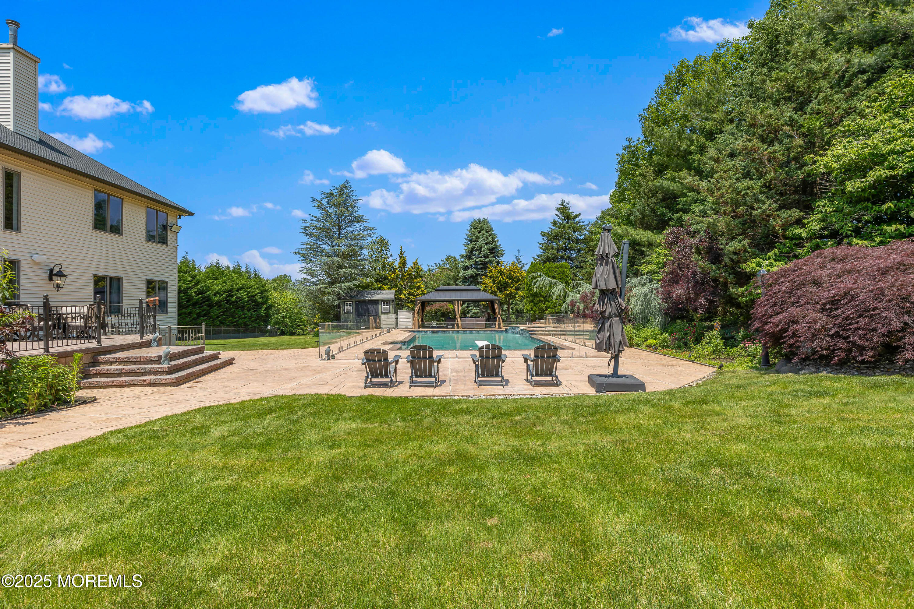 806 Turquoise Trail Morganville, NJ 07751 - Photo 61 of 62 a view of a house with a yard porch and sitting area
