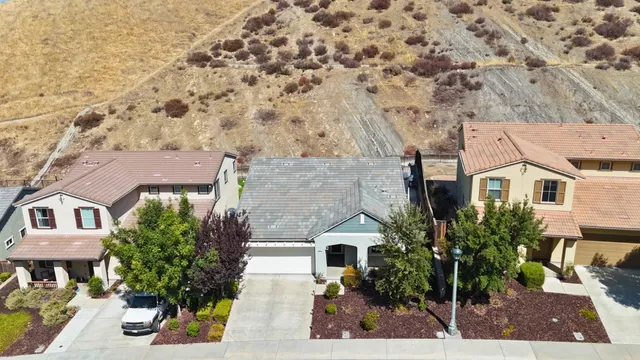 an aerial view of a house with a yard