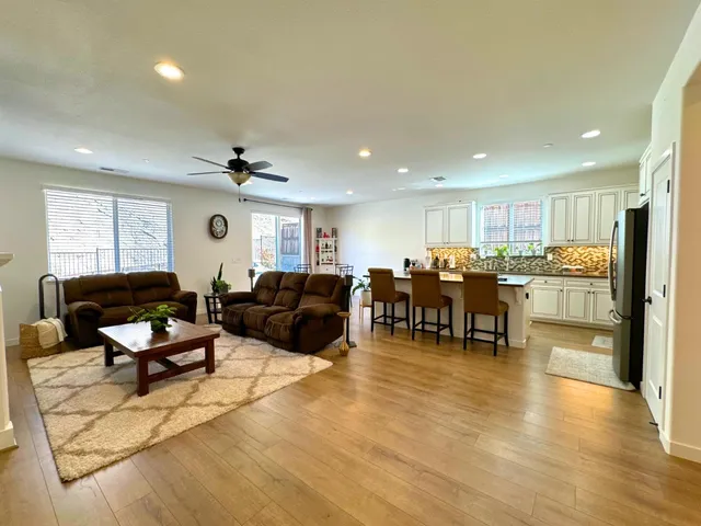 a living room with furniture and kitchen view