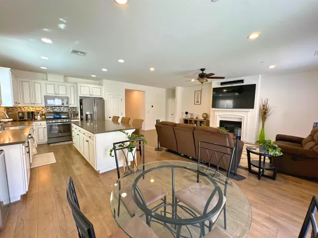 a living room with fireplace furniture and a flat screen tv