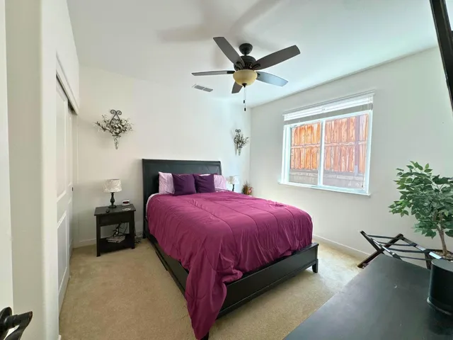 a bedroom with a bed and window