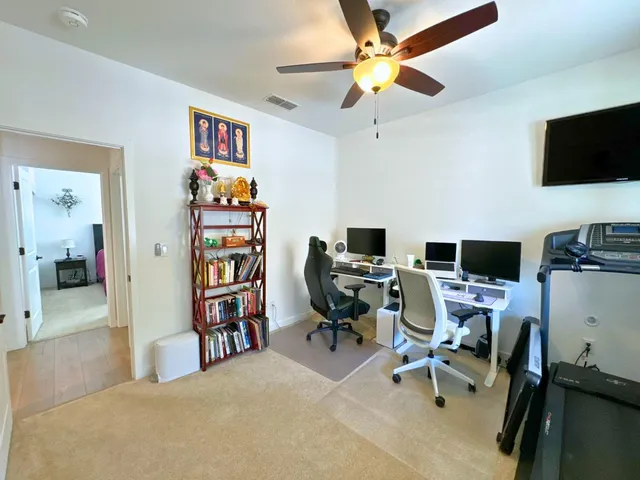 a bedroom with a workspace