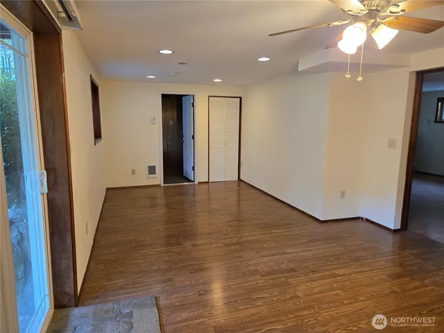 a view of a hallway with wooden floor