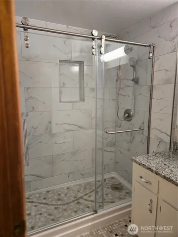a bathroom with a shower and a sink