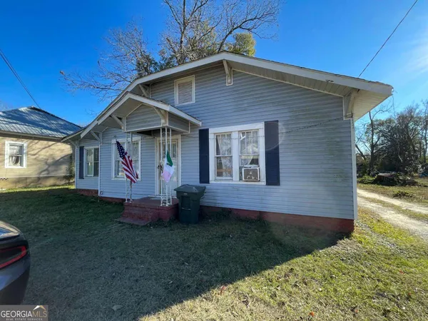 a view of house with backyard