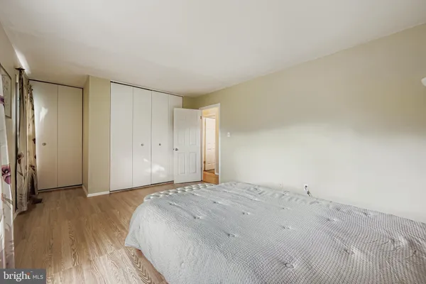 a bedroom with a bed and a large mirror