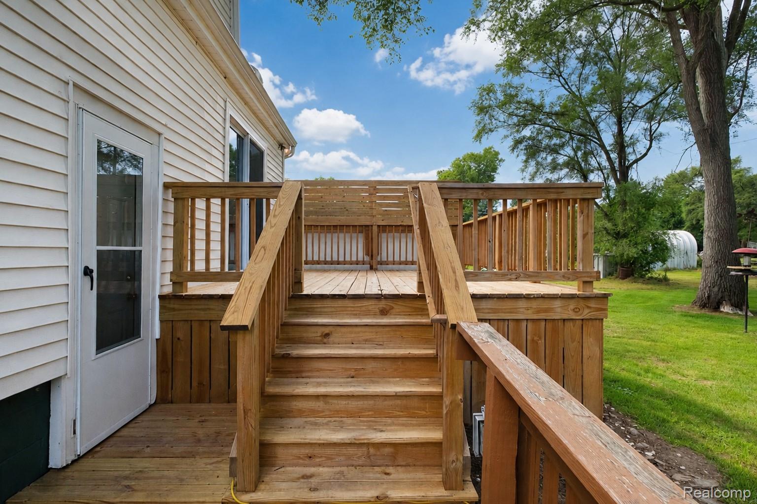 3363 East Pierson Road Flint, MI 48506 - Photo 20 of 27 Outdoor wood deck with staircase and railing