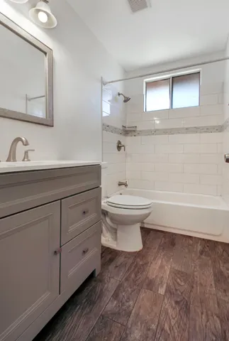 a bathroom with a sink a toilet and mirror