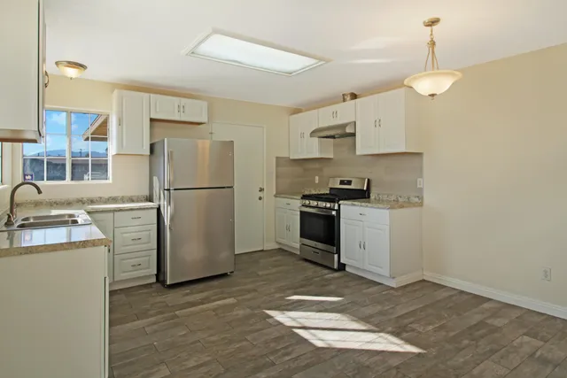 a kitchen with cabinets and stainless steel appliances
