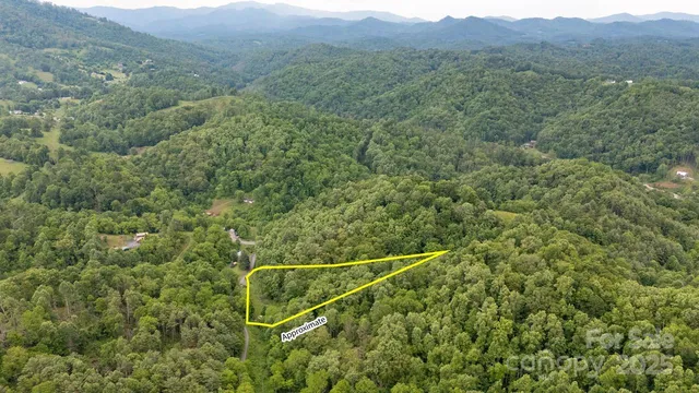 a view of a green field with mountains in the background