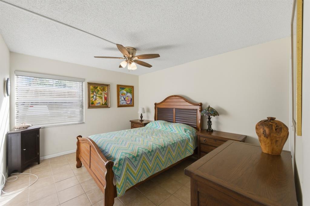 820 Flanders South, Unit 280 Delray Beach, FL 33484 - Photo 12 of 16 a bedroom with a bed and window