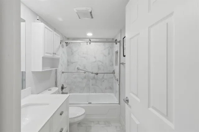 a bathroom with a sink toilet and shower
