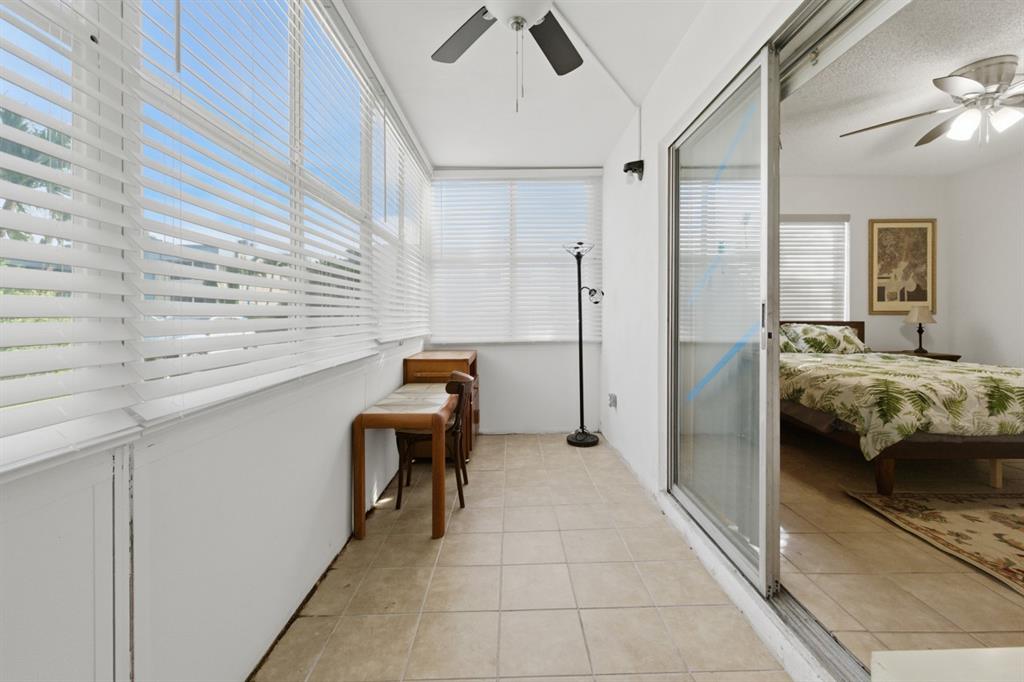 820 Flanders South, Unit 280 Delray Beach, FL 33484 - Photo 14 of 16 a view of a bedroom with a bed and a window