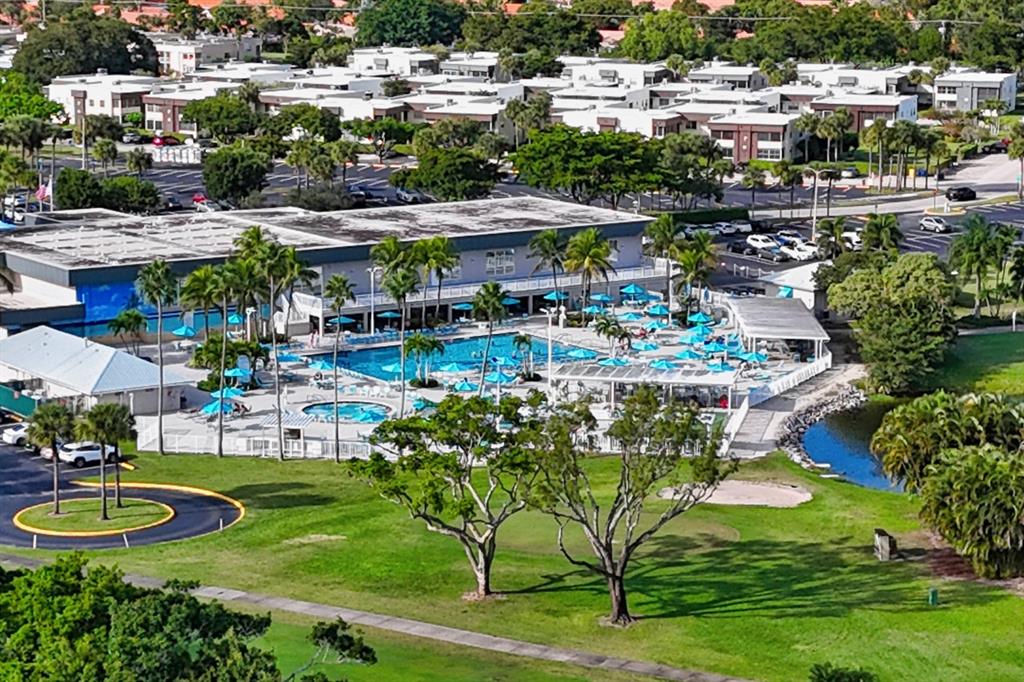 820 Flanders South, Unit 280 Delray Beach, FL 33484 - Photo 16 of 16 a view of a swimming pool with a table and chairs