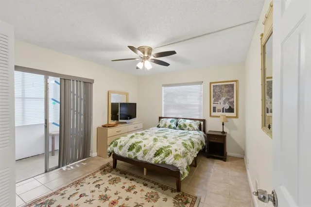 a bedroom with a bed and a large mirror with a wooden floor
