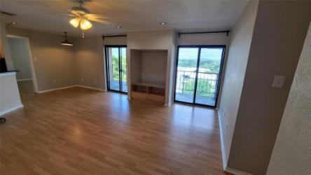 2409 Leon Street, Unit 301 Austin, TX 78705 - Photo 4 of 10 an empty room with wooden floor and windows