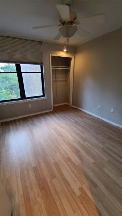 2409 Leon Street, Unit 301 Austin, TX 78705 - Photo 6 of 10 an empty room with wooden floor and windows