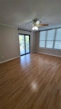 2409 Leon Street, Unit 301 Austin, TX 78705 - Photo 7 of 10 a view of empty room with wooden floor and fan